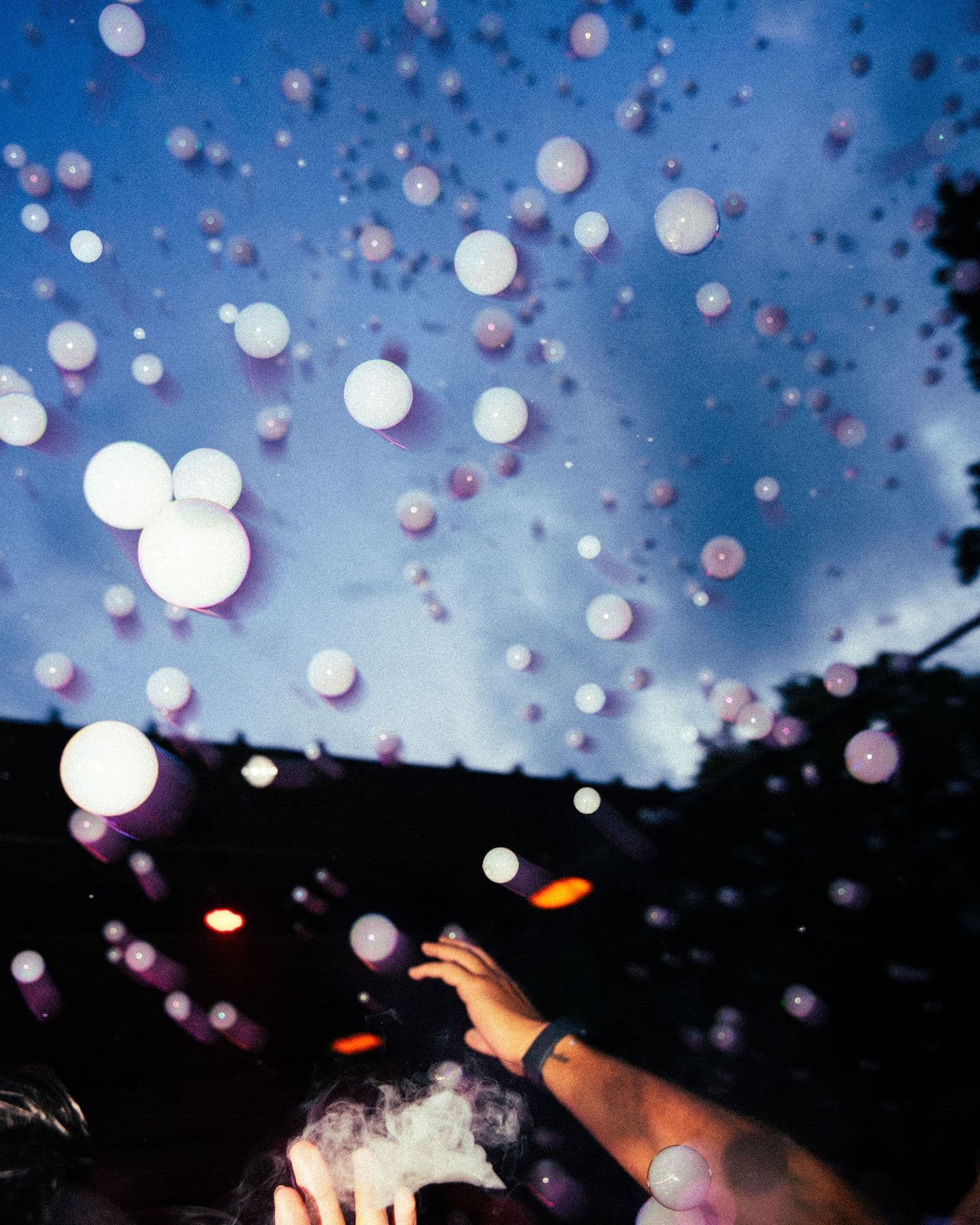 Bubbles floating against the evening sky