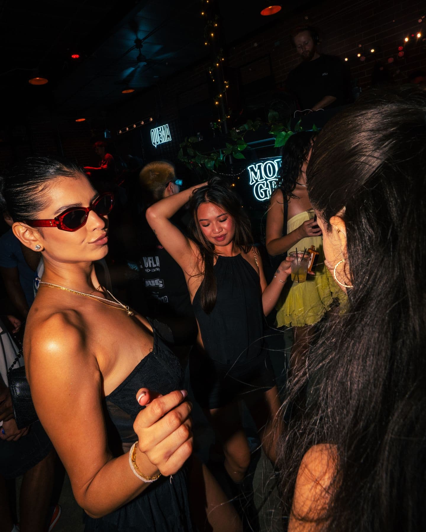 A dancer in sunglasses on the District patio